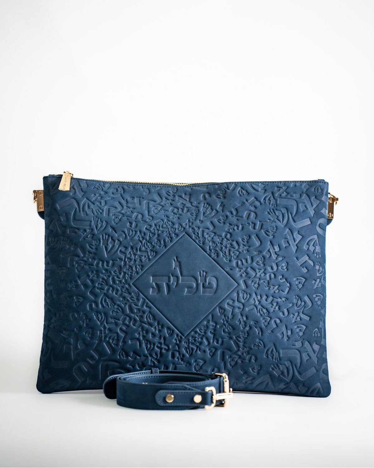Blue embossed leather tallit bag with a matching strap on white