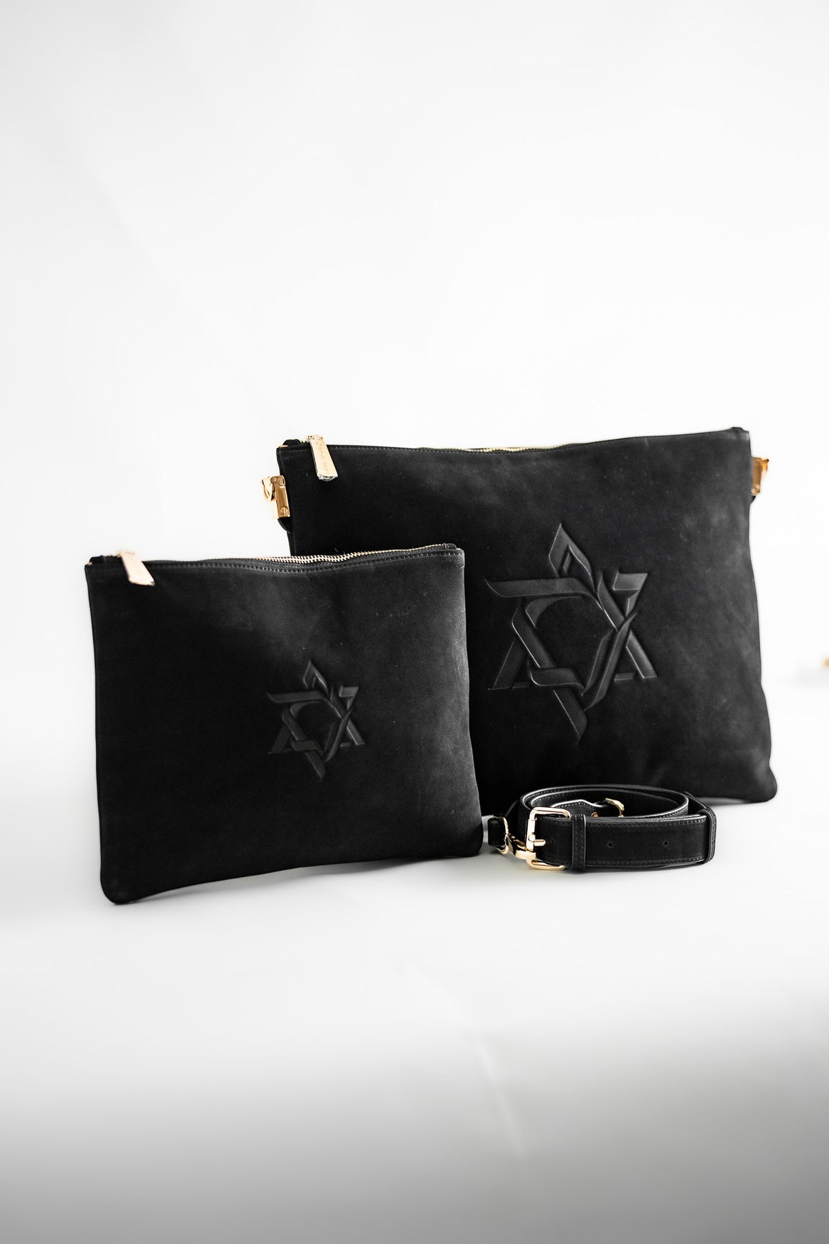 Black Magen David leather tallit and tefillin bag set standing together