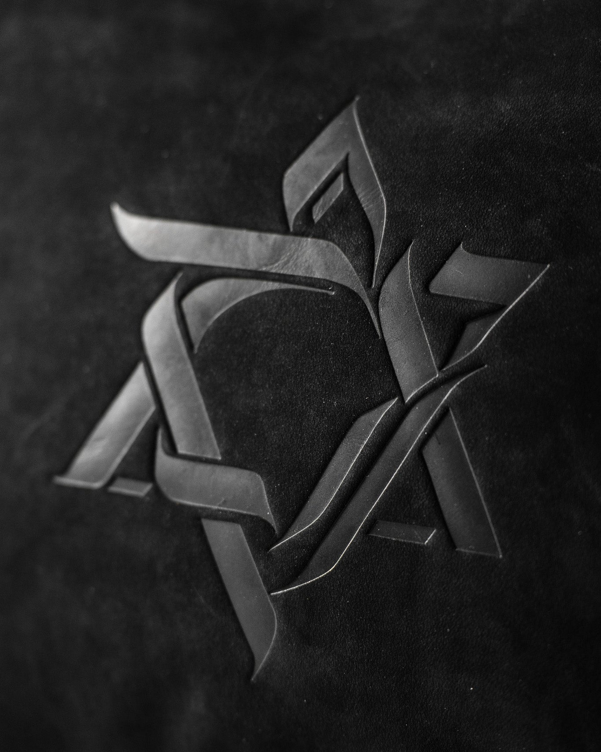 Close-up of the embossed Magen David on black Italian leather