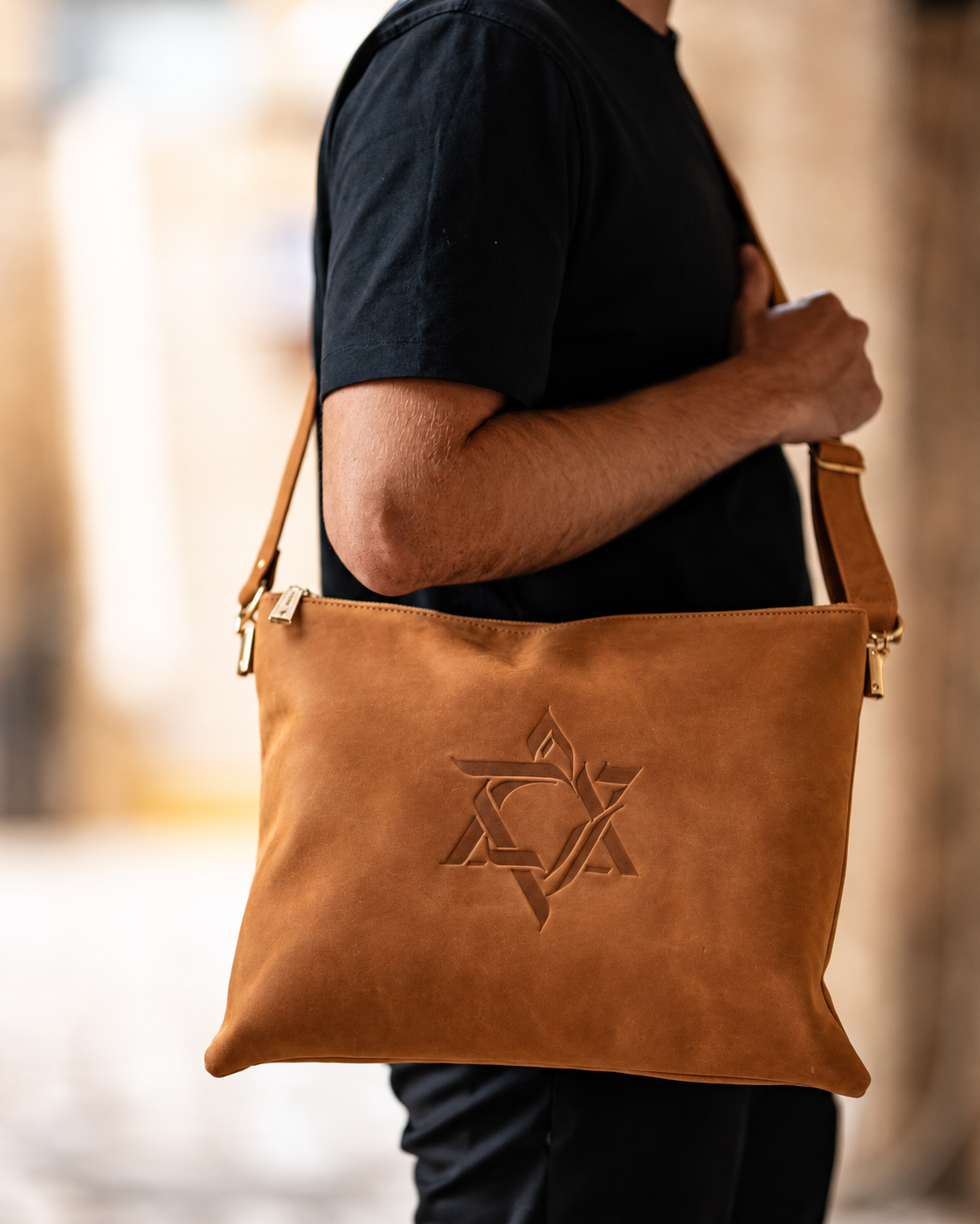 Man carrying the natural leather Magen David tallit bag on his shoulder