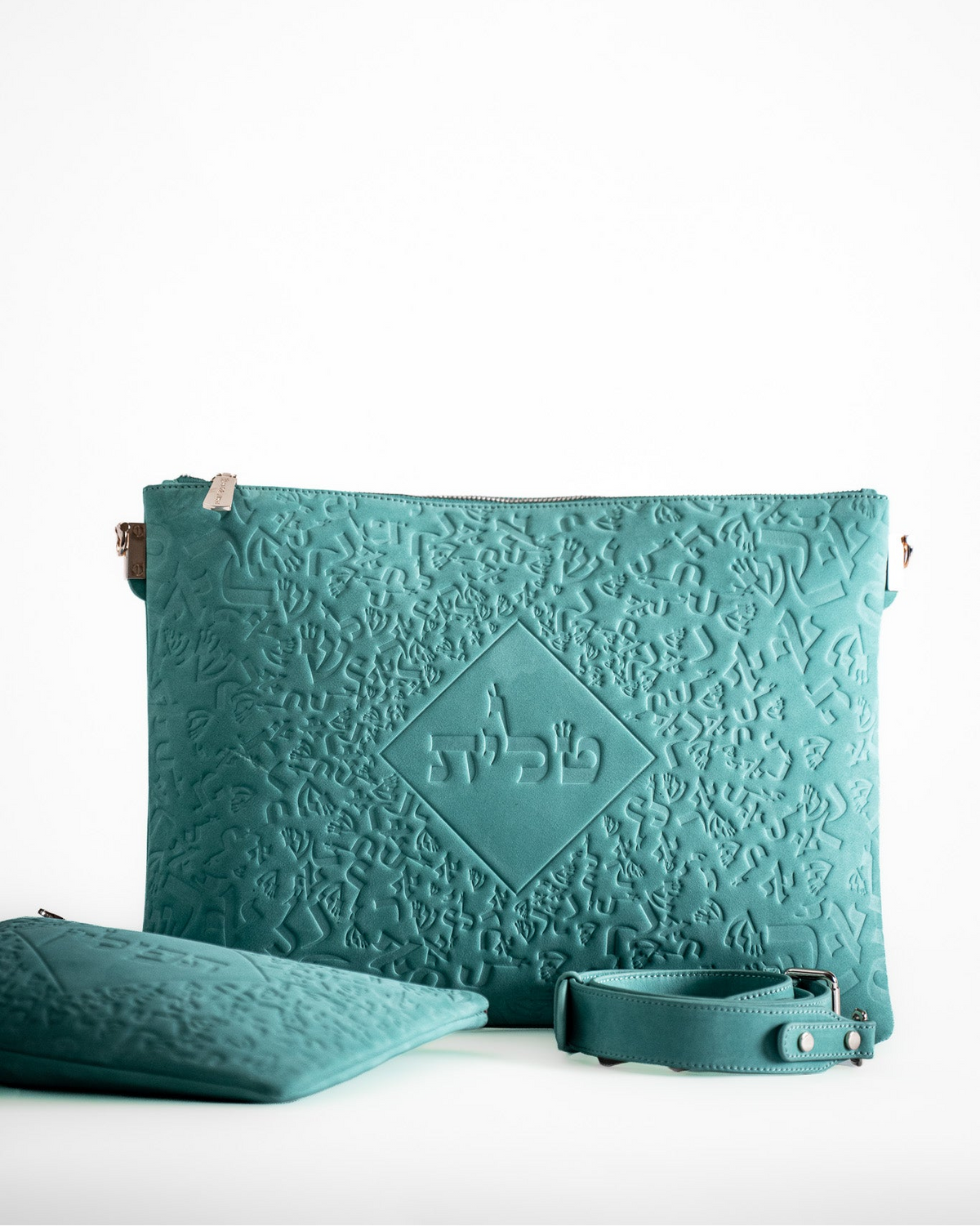 Turquoise leather tallit bag lying beside the tefillin bag