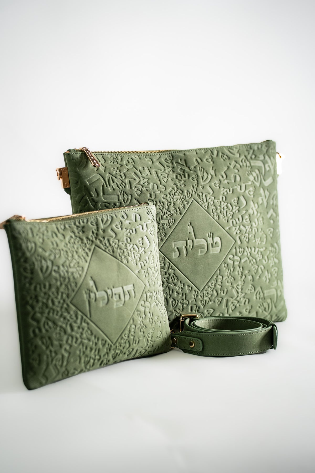 Green leather tallit bag and tefillin bag with a strap, three quarter view