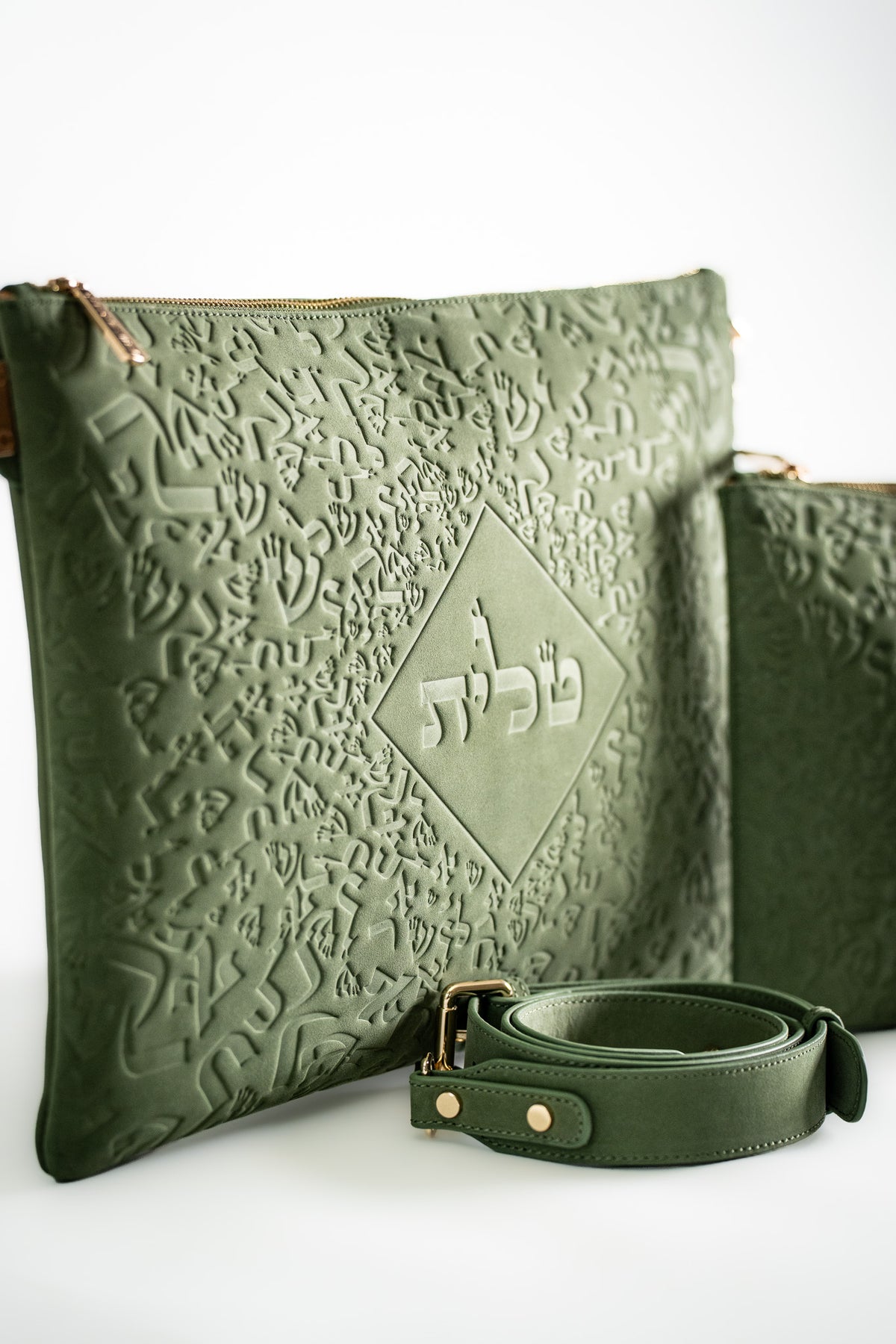 Embossed green leather tallit bag with a matching green strap