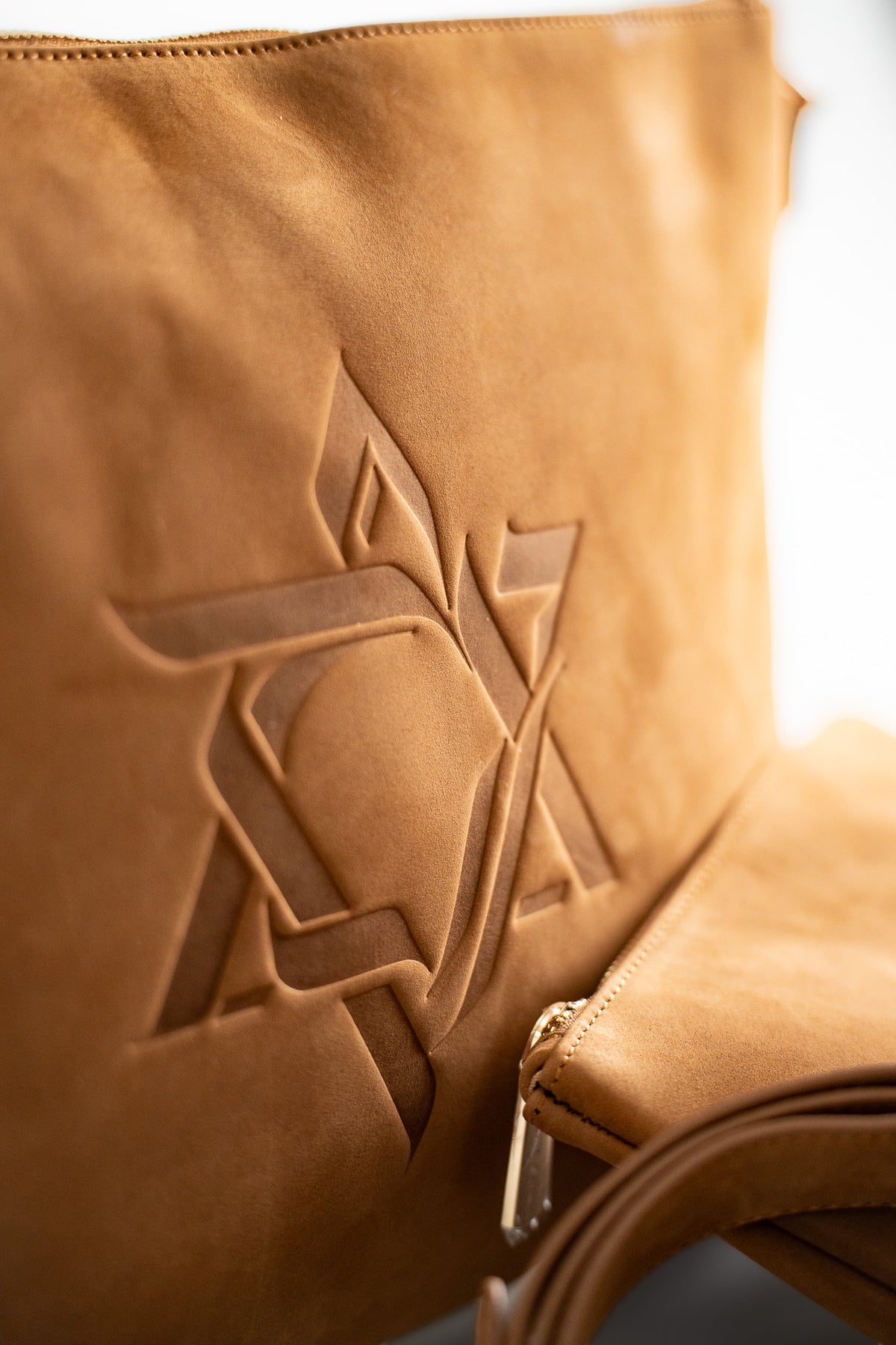Close-up of the embossed Magen David on natural tan leather