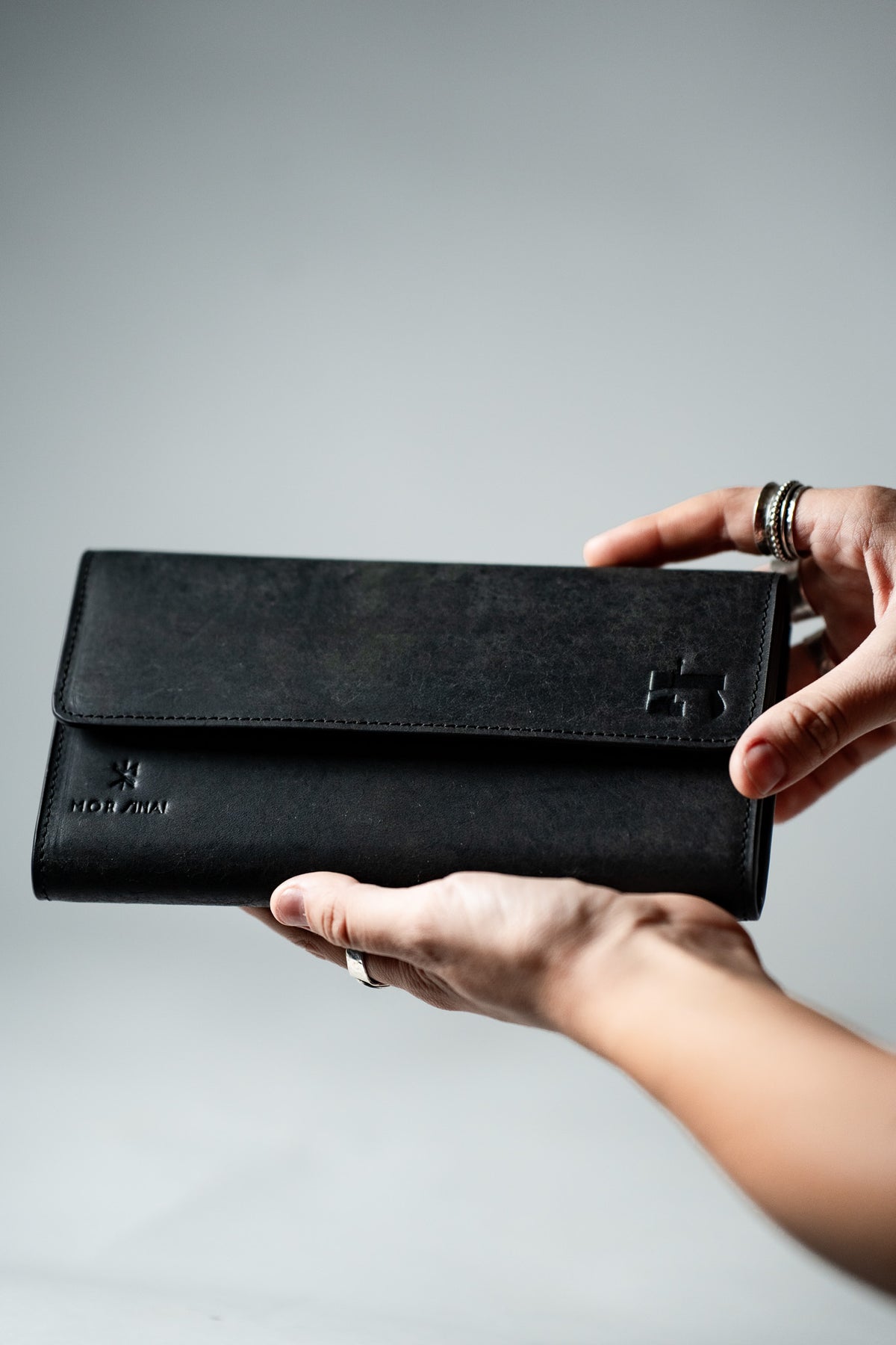 Black leather ladies wallet held open in a hand