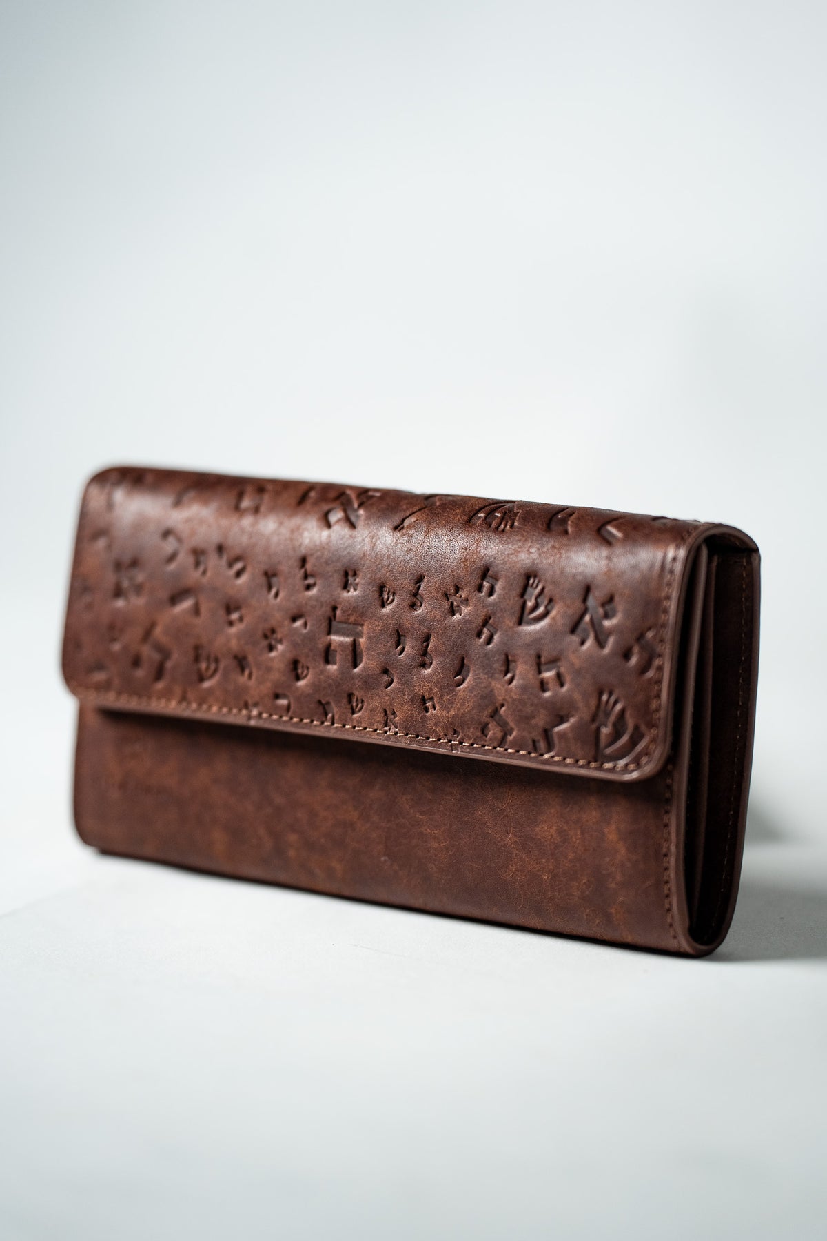Brown leather ladies wallet closed, three quarter view