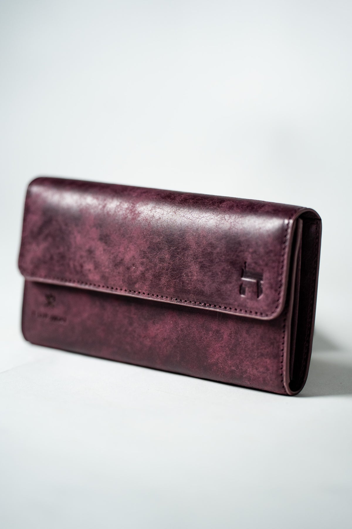 Burgundy leather ladies wallet closed, front view
