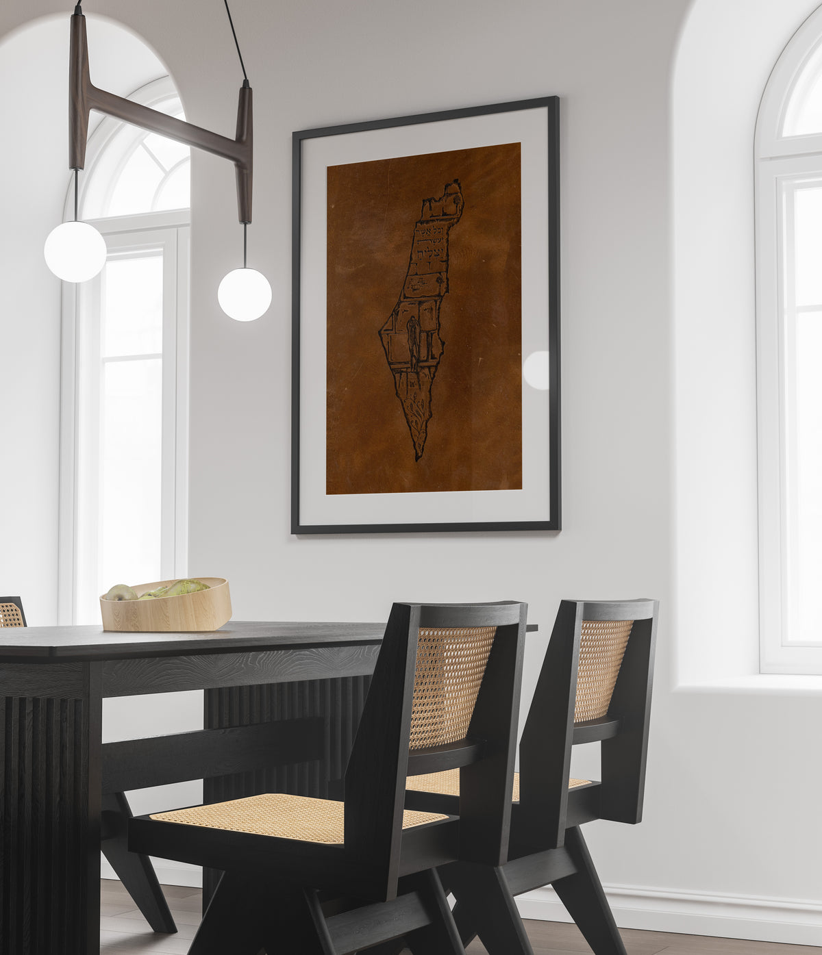 Framed leather Land of Israel art hanging above a dining table