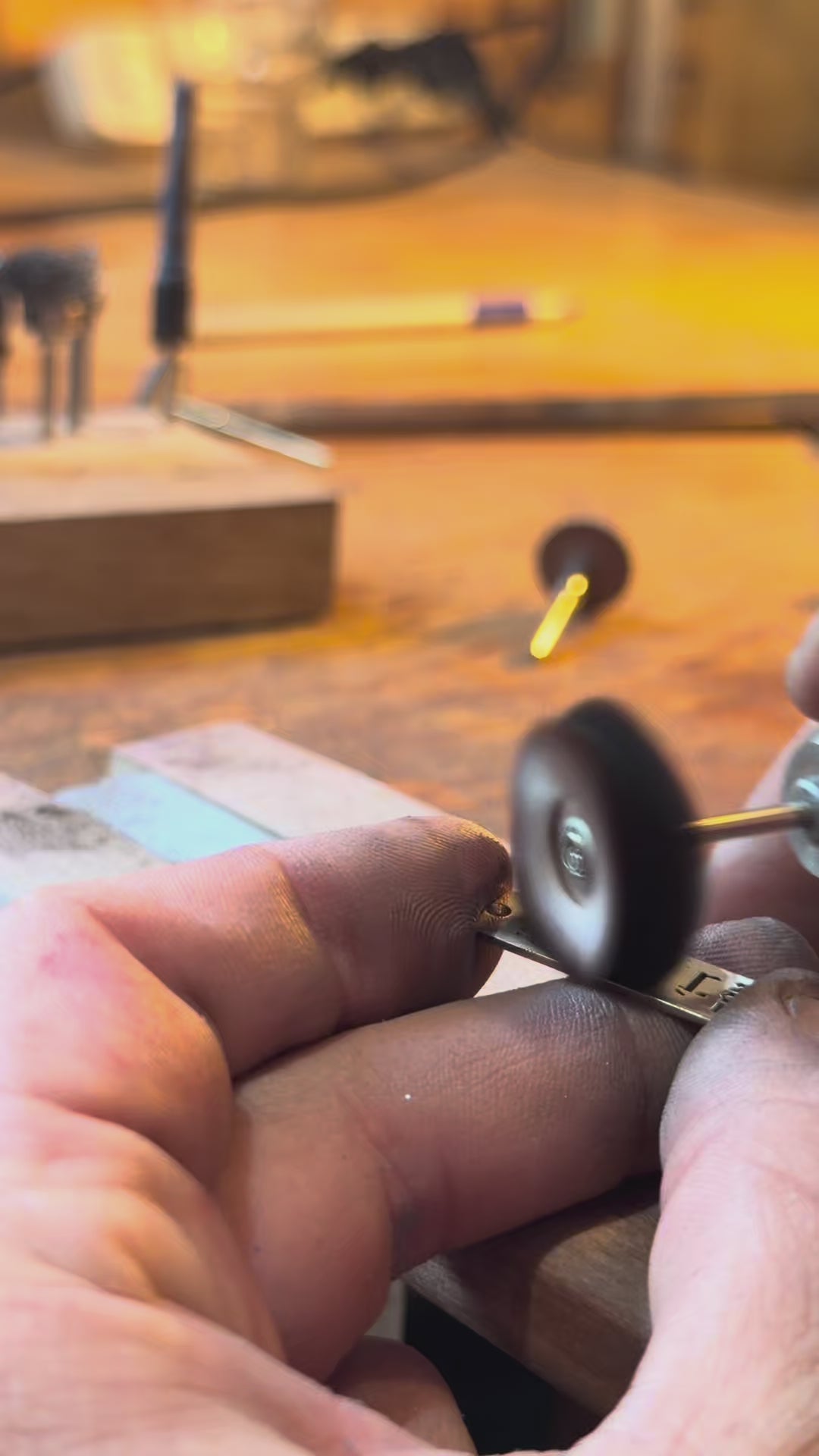 Video of a silver pendant being hand finished with a rotary tool at the jeweler's bench